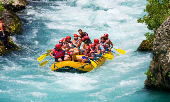 Group white-water rafting on a Kashmir river in summer